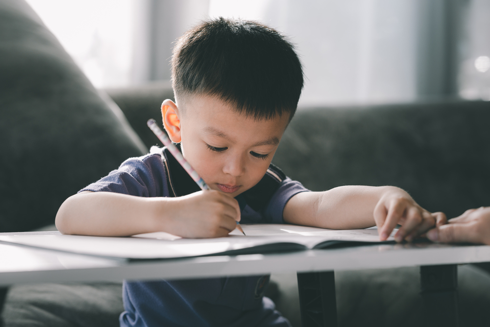asian boy doing homework